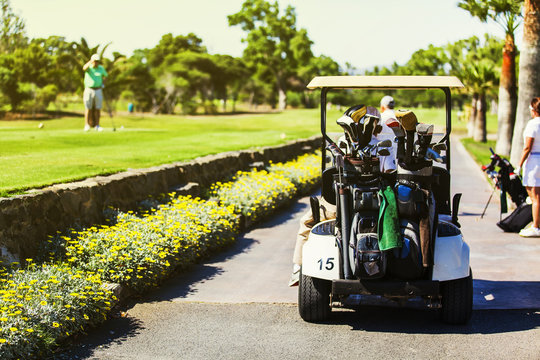 Golf match. People preparing to play golf. Golf buggy.