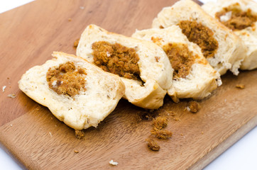 dried shredded pork bread on cutting board on a white background
