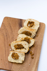 dried shredded pork bread on cutting board on a white background