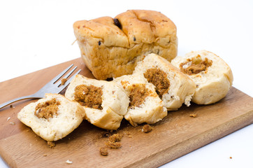 dried shredded pork bread on cutting board on a white background