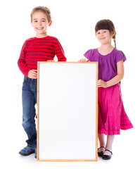 Cute girl and boy showing blank ad