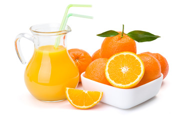 Orange fruits and jug of juice