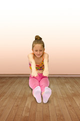 cute little gymnast does exercises