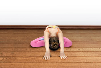 little girl practices yoga