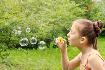 Portrait of the girl who are starting up soap bubbles