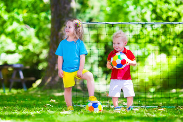 Children playing football outdoors