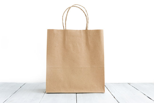 Paper bag on the wooden background