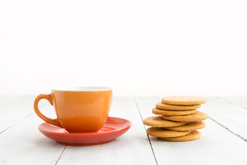 Cup of tea and biscuits on wooden background