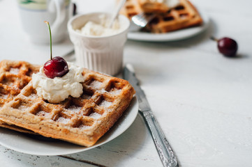 Breakfast with wholegrain waffles and whipped cream