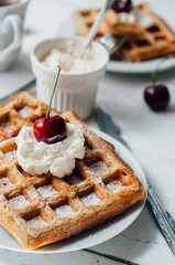 Breakfast with wholegrain waffles and whipped cream