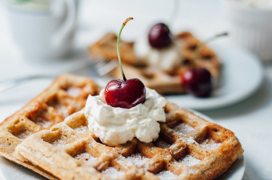 Breakfast with wholegrain waffles and whipped cream