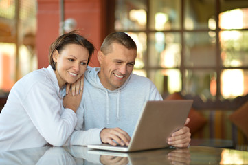 Happy couple with laptop