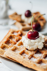 Breakfast with wholegrain waffles and whipped cream