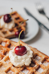 Breakfast with wholegrain waffles and whipped cream