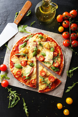 Fresh tasty pizza on black background