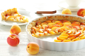 Apricot pie on white wooden background