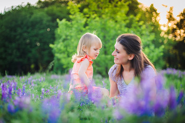 Mother and daughter on field with flowers