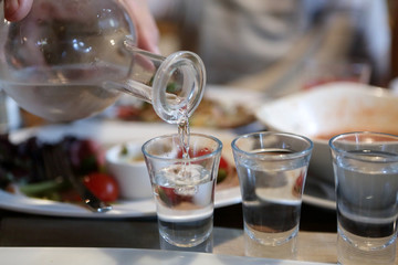 Person pouring vodka