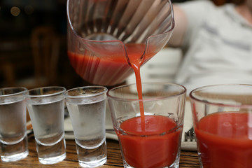 Person pouring tomato juice