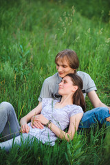 Fototapeta premium Couple in love on meadow on green grass