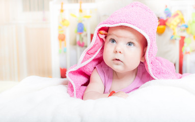 Cute baby lying on the bed after bath