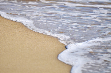 selective focus of close up waves at the beach