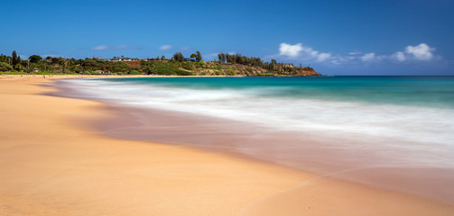 Day time long exposure at Kealia beach on the tropical island of Kauai, Hawaii - obrazy, fototapety, plakaty