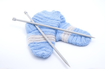 Knitted wool socks and knitting needles..