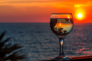 white wine at sunset reflecting in cup