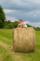 two happy boys on hay bales