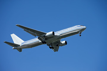 Fototapeta na wymiar flying airplane on blue sky background