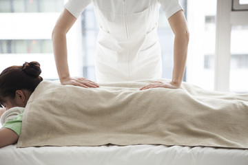 Manipulative nurses are massaging a woman's back