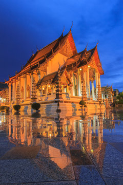 Temple in bangkok wat suthat at twilight time and reflection later raining , Thailand