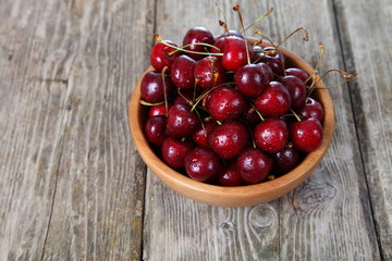 Ripe cherry in a wooden bowl
