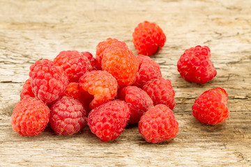 ripe raspberries closeup on wooden background