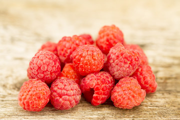 ripe raspberries closeup on wooden background