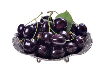 Fresh ripe black cherries in a glass bowl, Isolated 