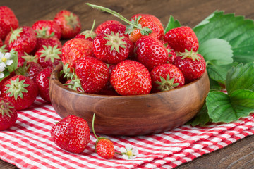 Organic Strawberries in bowl on wooden background