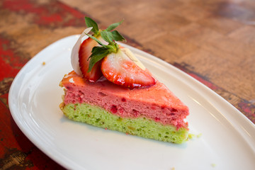 Pink strawberry cheese cake on white dish