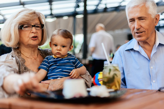 Grandparents With Their Grandson At Cafe