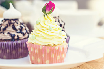 Light yellow Cupcake with rose on the table