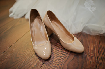 cream colour wedding  shoes on the wooden floor