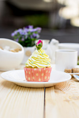 Light yellow Cupcake with rose on the table