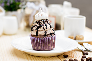 Chocolate Cupcake with chocolate frosting on the table