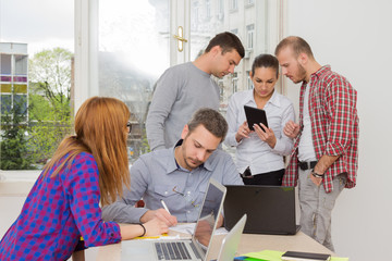 Young group of people discussing business plans.