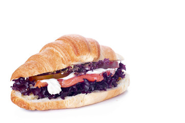 Croissant sandwich with salted salmon on plate,