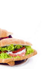 Croissant sandwich with salted salmon on plate,
