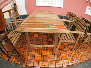 Wet wooden table and chairs after the rain