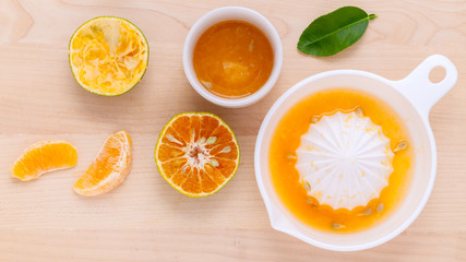 Freshly orange juice with orange slice set up on wooden table .