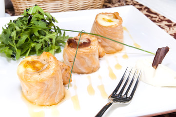 baked salmon rolls on a table in a restaurant
